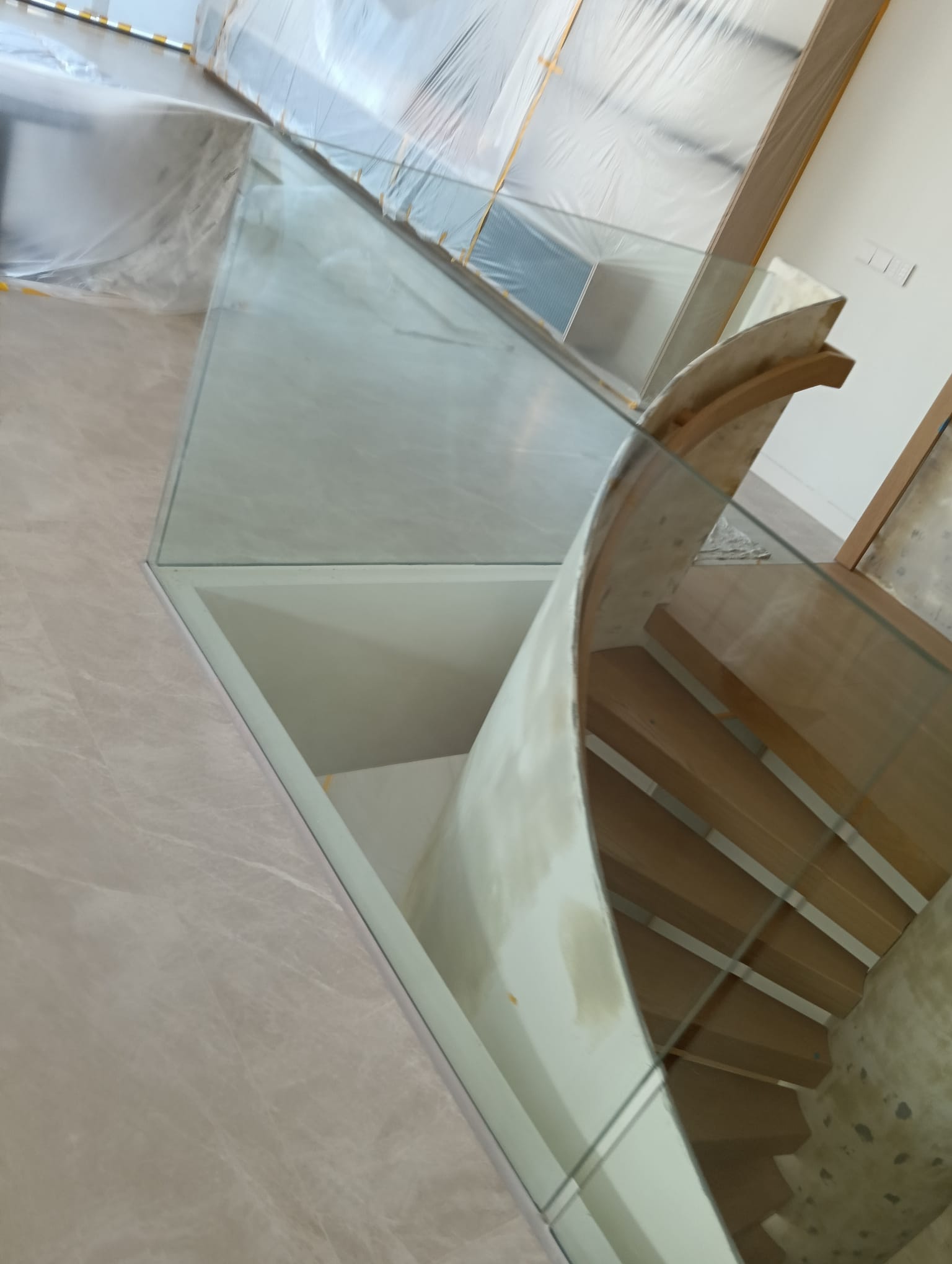 Glass panels around a timber staircase, showing their shape and position within the installation