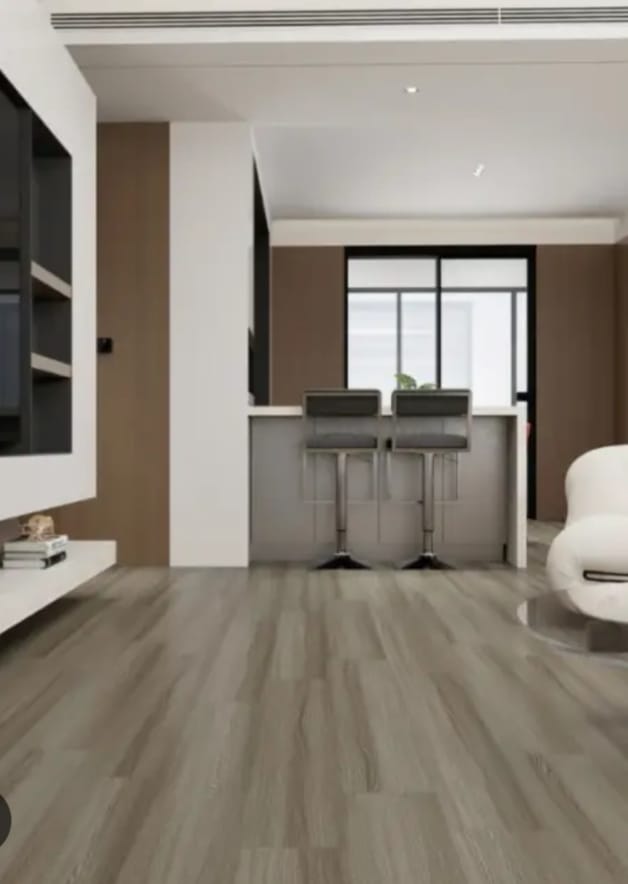 Pale grey plank-style flooring in an open-plan living area with a counter and two bar stools
